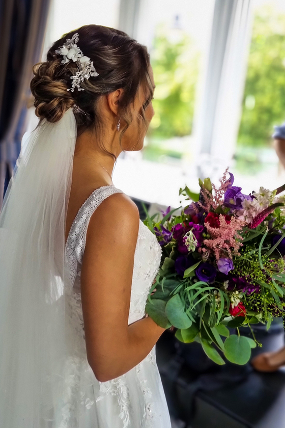 Side view of bride with wildflower bouquet 